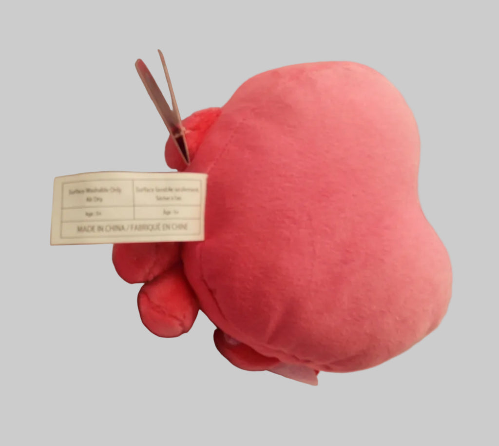 A pink plush heart-shaped octopus toy with a white product tag attached, photographed on a wrinkled white fabric background.