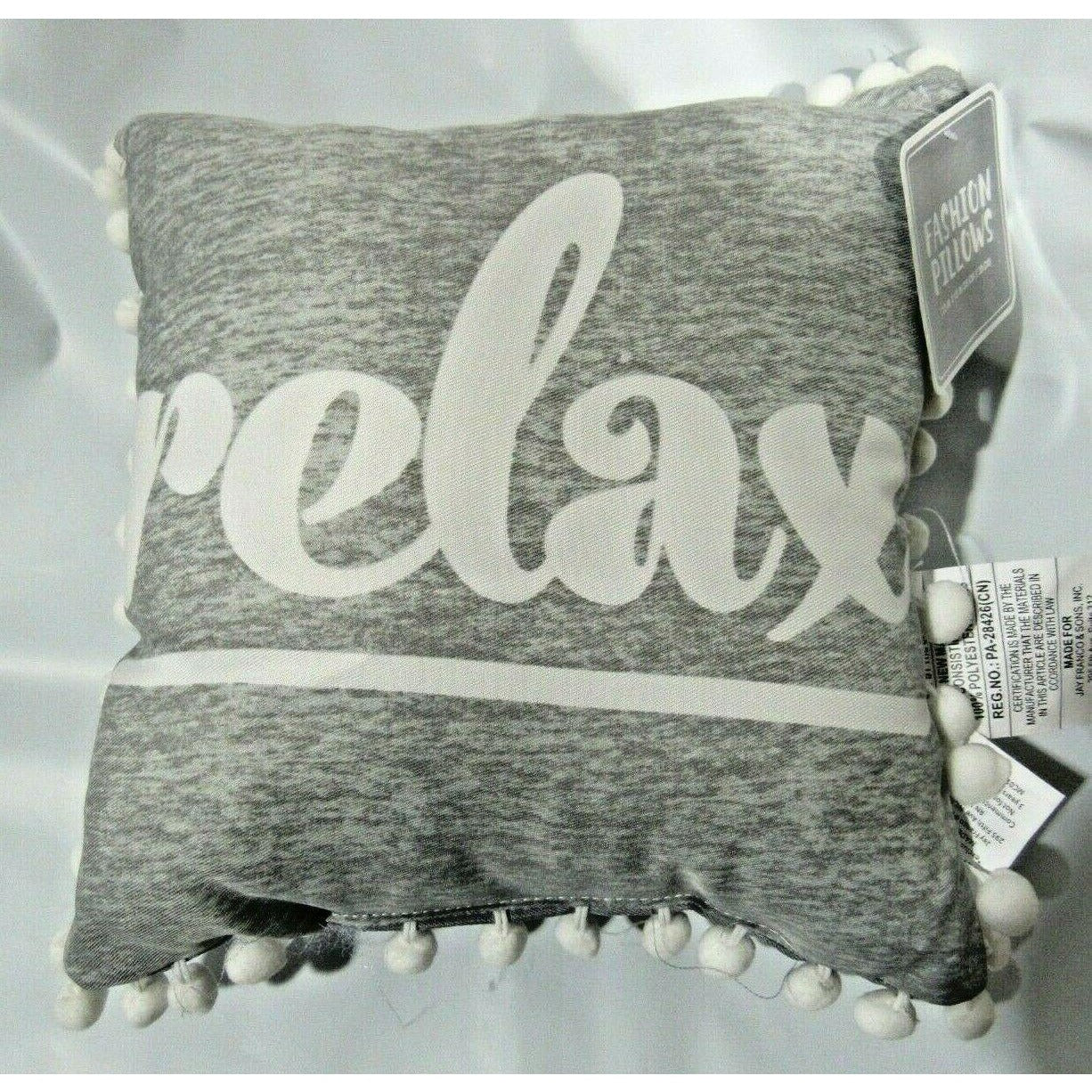 "relax" on Gray 12" by 12" Pillow with Pom Poms by Jay Franco & Sons, Inc.